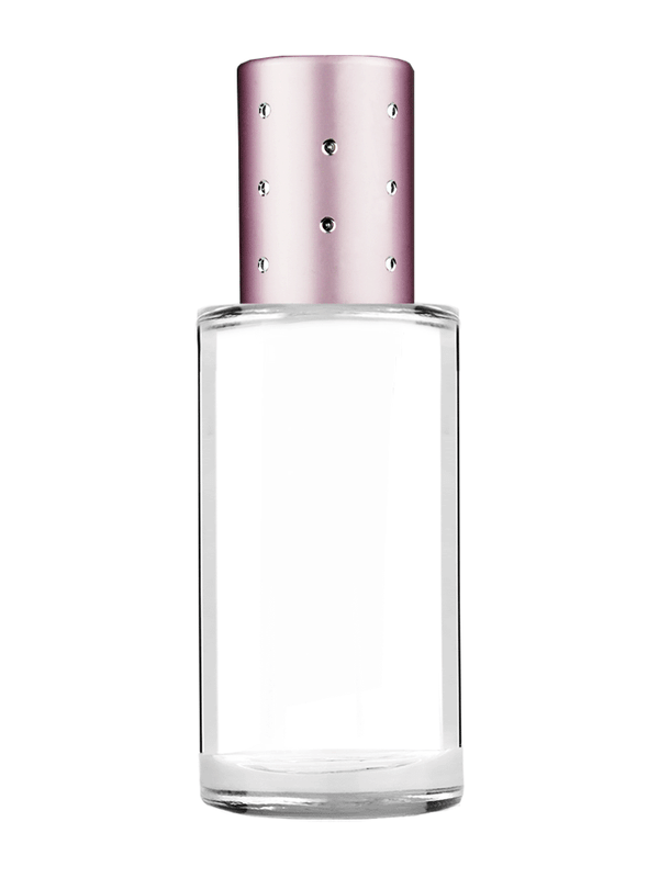 Pillar design 9ml Clear glass bottle with metal roller ball plug and pink cap with dots.