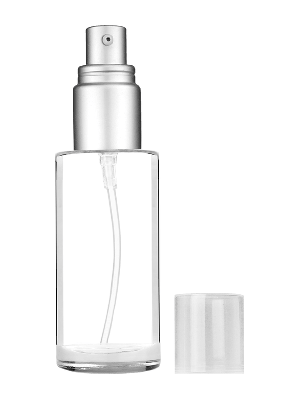 Cylinder design 25 ml clear glass bottle  with with a matte silver collar treatment pump and clear overcap.
